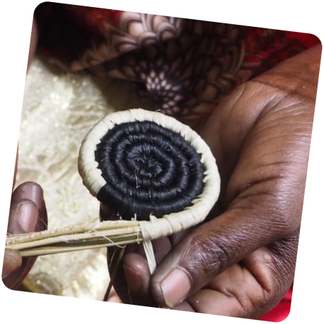 A close-up of a woven basket being made by an AfriBead artisan